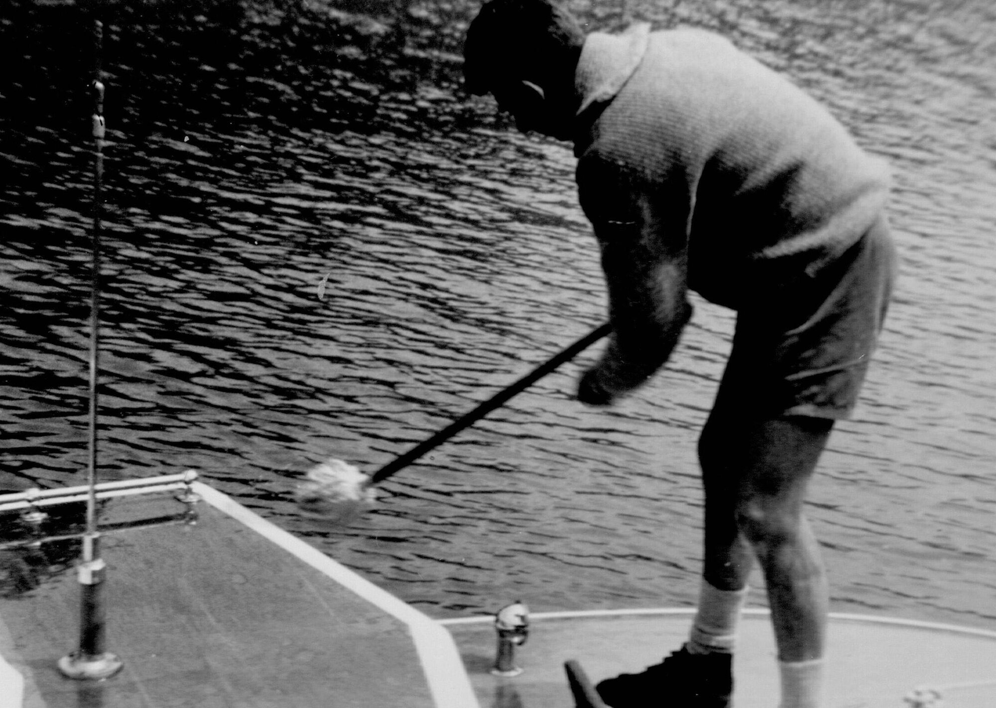 Wally Sander washing the deck of the park boat