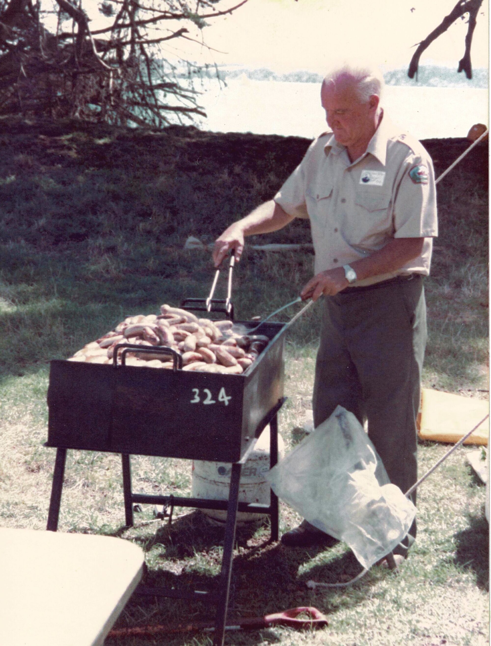 George Holmes tends the BBQ at Browns Island - Hauraki Gulf maritime Park