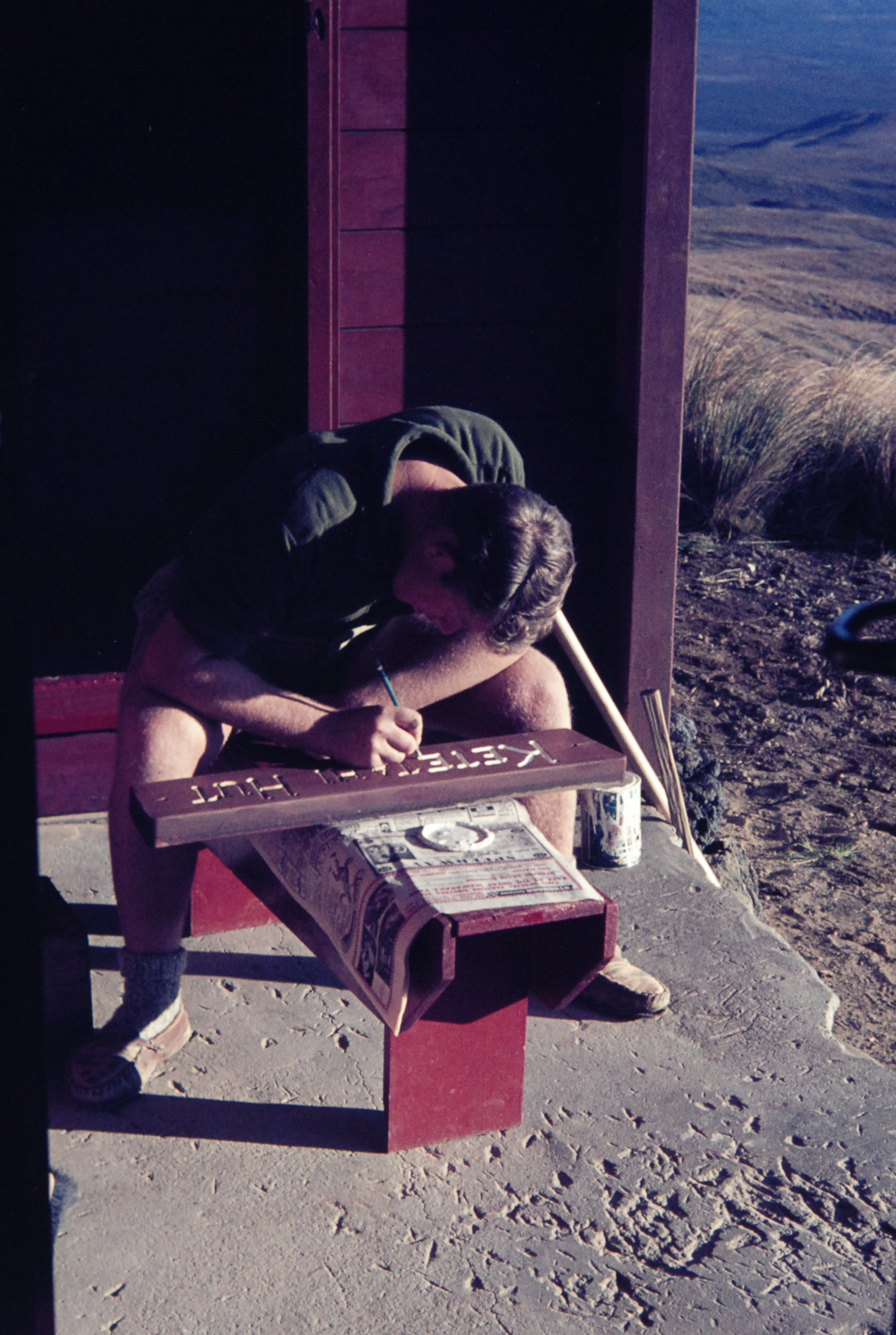 Painting the Ketetahi Hut sign: Tongariro National Park