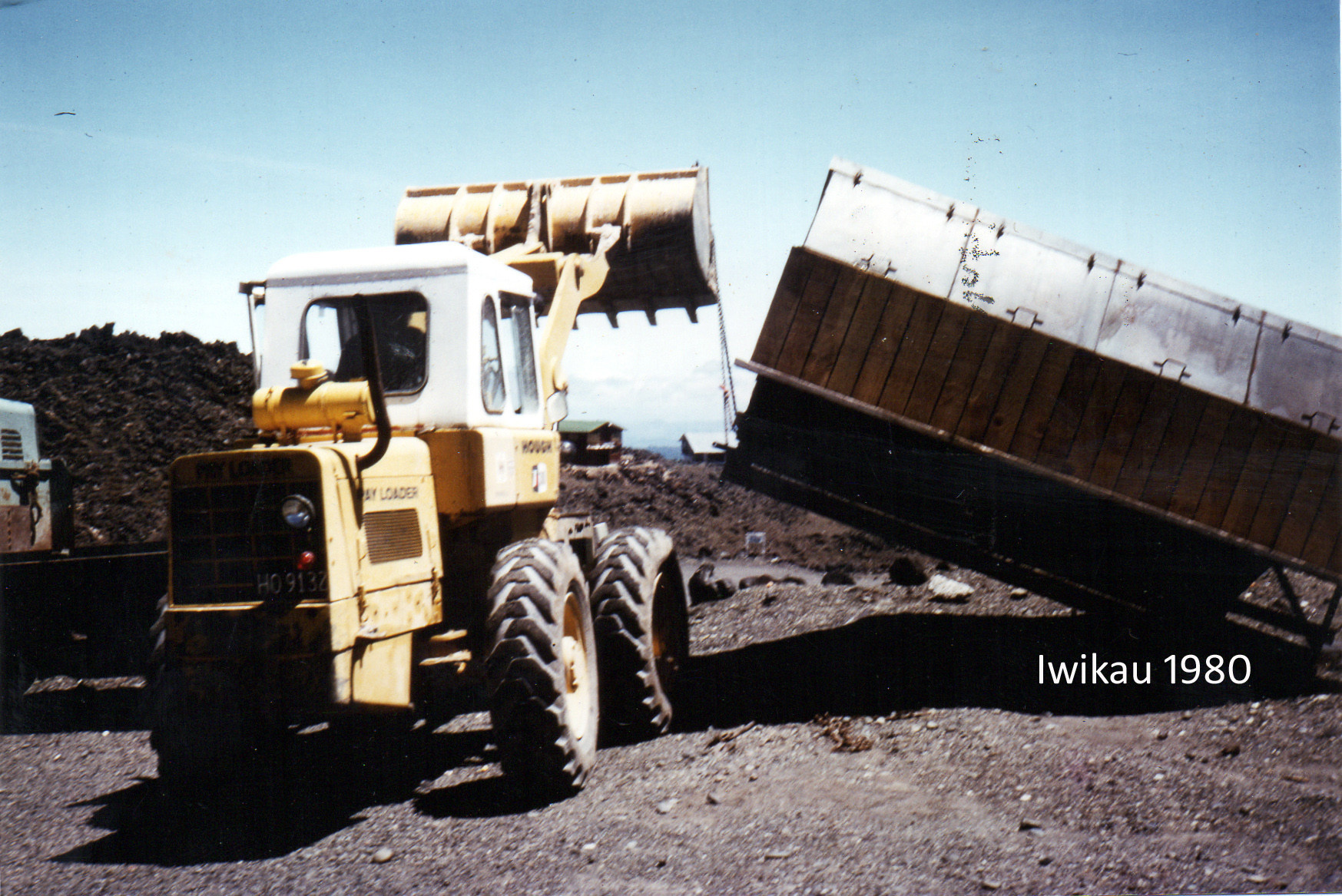 Phil Smith drove the truck and Hough Pay Loader, seen here, to lift the heavy hopper into place.
