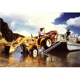 Dave Hayes loading the lawnmower (tractor) at Urupapukapuka Island 1986