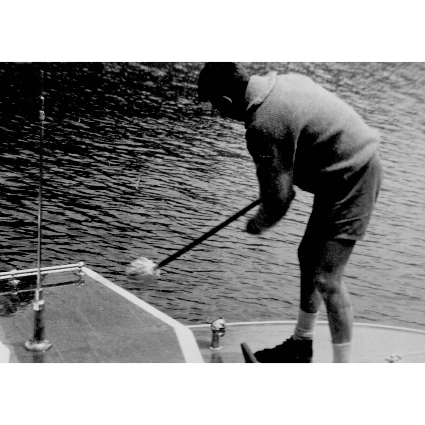 Wally Sander washing the deck of the park boat